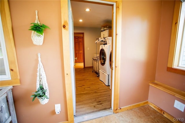 corridor featuring washing machine and clothes dryer and light wood-type flooring