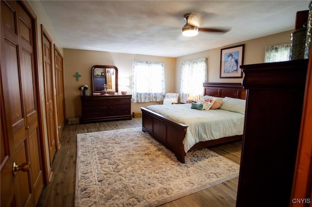 bedroom with hardwood / wood-style flooring and ceiling fan