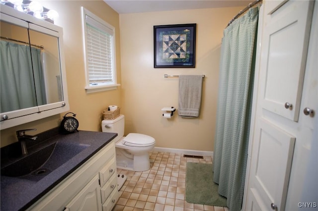 bathroom with vanity, tile patterned floors, and toilet