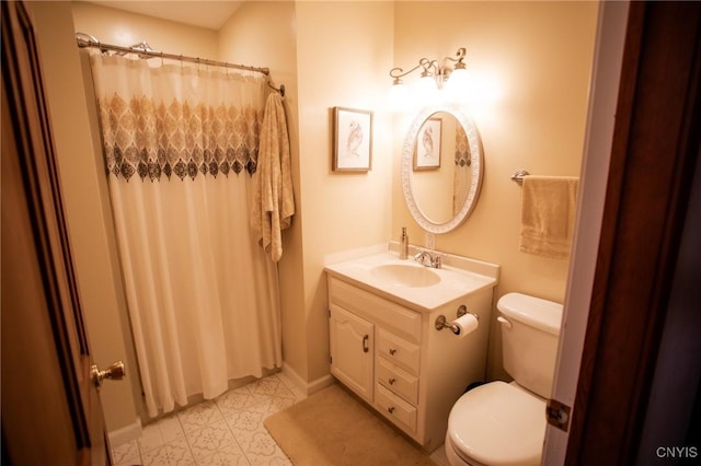 bathroom featuring walk in shower, vanity, and toilet