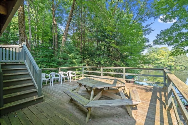 wooden deck with stairs and outdoor dining area