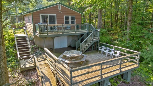 back of property featuring stairway and a wooden deck