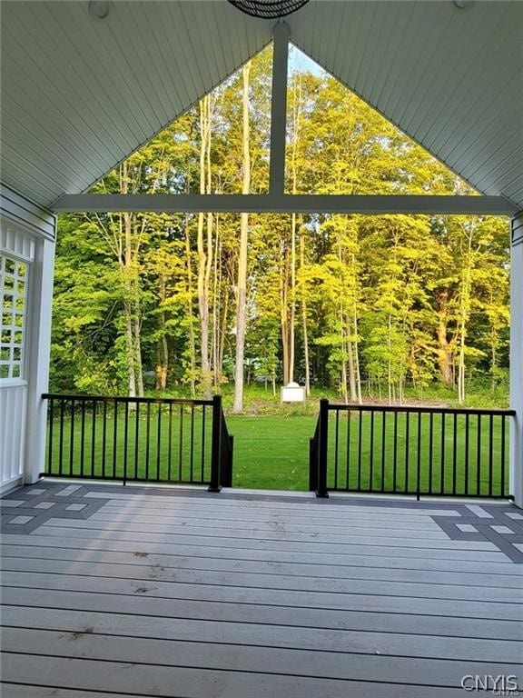 wooden deck featuring a yard