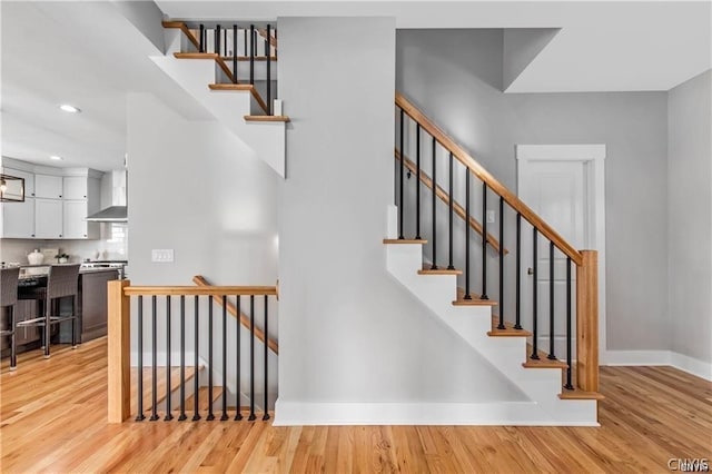 staircase featuring light hardwood / wood-style floors