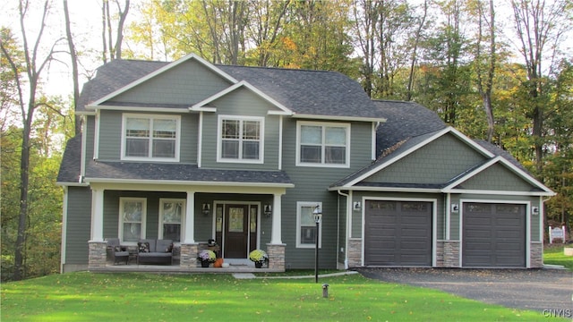 craftsman-style home featuring a porch and a front lawn