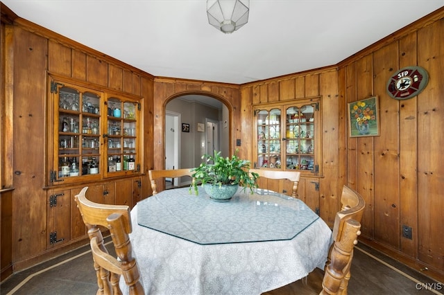 dining area featuring wood walls