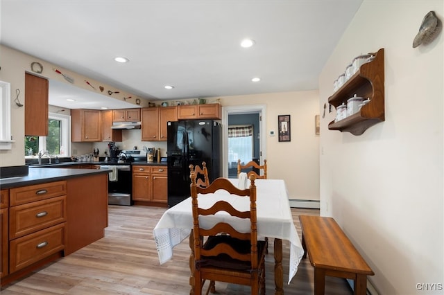 kitchen with light hardwood / wood-style flooring, a baseboard heating unit, black refrigerator with ice dispenser, stove, and sink