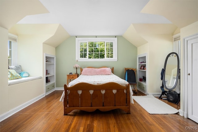 bedroom with lofted ceiling and hardwood / wood-style floors