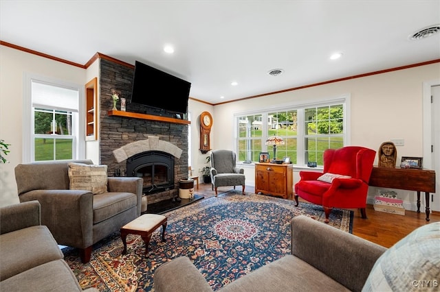 living room with a fireplace, crown molding, and wood-type flooring