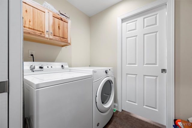 washroom featuring washer and dryer and cabinets