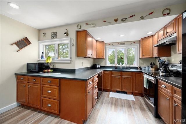 kitchen with sink, black appliances, and light hardwood / wood-style floors