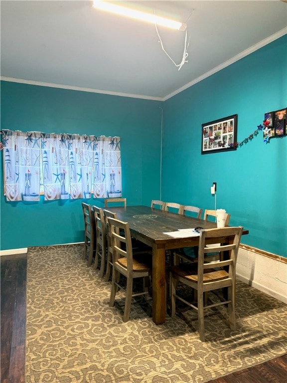 dining area with hardwood / wood-style floors and ornamental molding