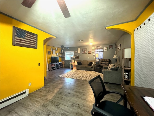 office space featuring ceiling fan, hardwood / wood-style floors, and baseboard heating