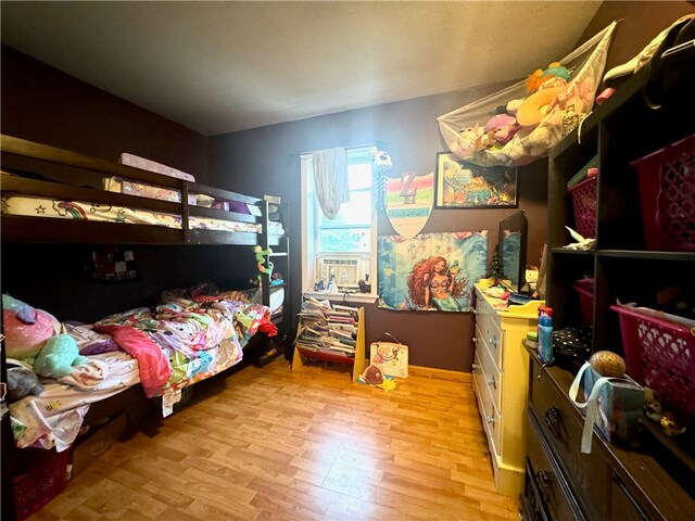 bedroom featuring cooling unit and light wood-type flooring