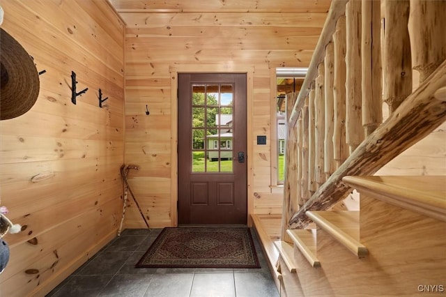 entryway featuring wood walls