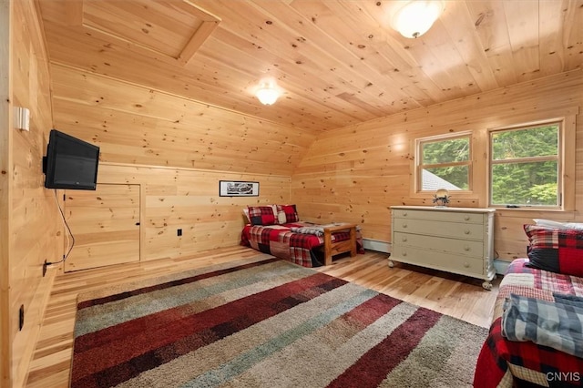 bedroom featuring light hardwood / wood-style floors, wooden ceiling, wood walls, and lofted ceiling