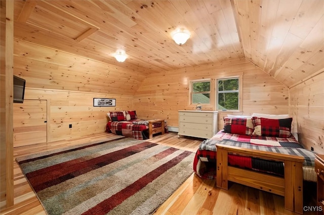 bedroom featuring wooden ceiling, wood walls, vaulted ceiling, wood-type flooring, and a baseboard radiator