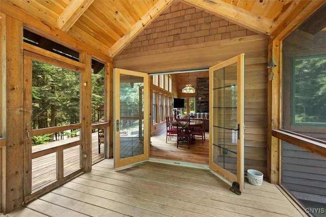 unfurnished sunroom with french doors, wooden ceiling, and vaulted ceiling with beams