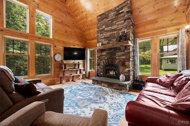 living room with a stone fireplace, wooden ceiling, high vaulted ceiling, and plenty of natural light