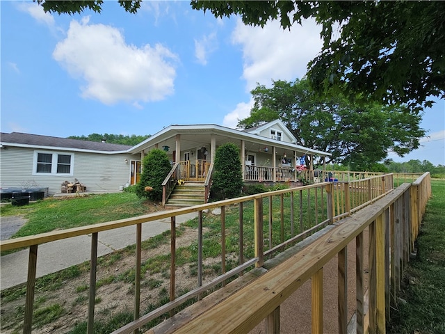 exterior space featuring a porch and a yard