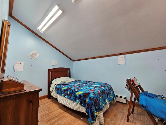 bedroom featuring vaulted ceiling, crown molding, a baseboard heating unit, and light wood-type flooring