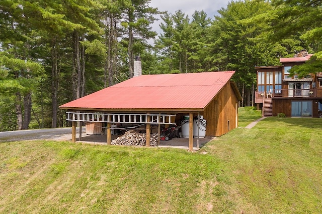 back of house featuring a deck and a lawn