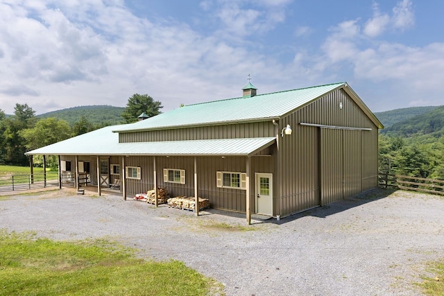 rear view of house featuring an outbuilding and a mountain view