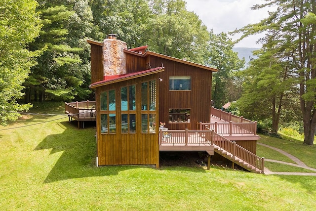 view of jungle gym featuring a lawn and a wooden deck