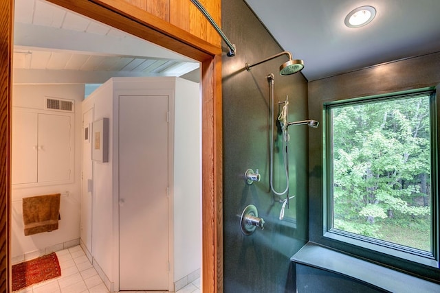 bathroom featuring vaulted ceiling with beams, tile patterned floors, and a wealth of natural light