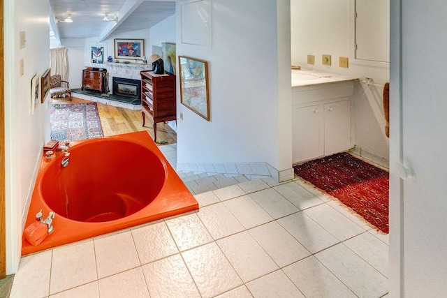 200 Onistagrawa Ln, Fulton, NY 12122 - full bath with vaulted ceiling, vanity, a tub to relax in, and tile patterned floors