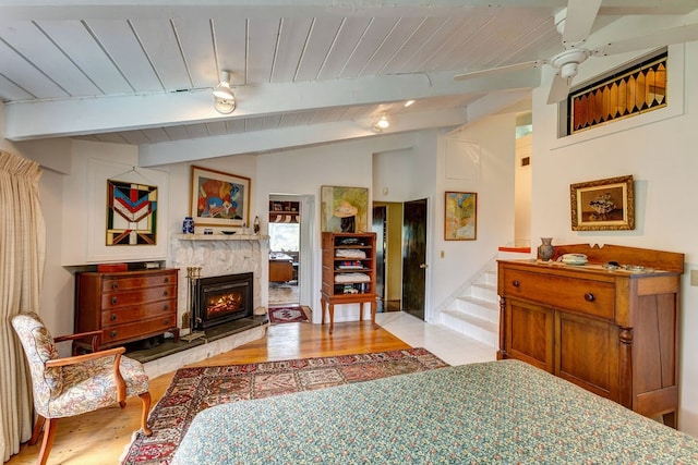 bedroom with ceiling fan, wood ceiling, lofted ceiling with beams, and light hardwood / wood-style floors