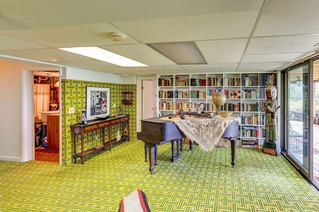 misc room featuring a drop ceiling and carpet flooring