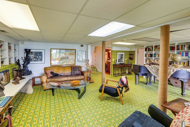 carpeted living room featuring a paneled ceiling