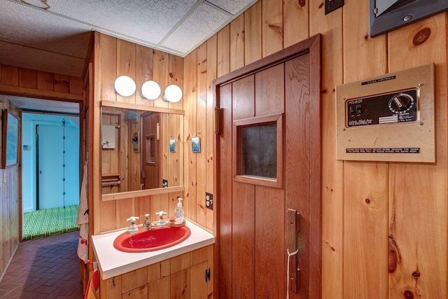 bathroom featuring vanity and wooden walls