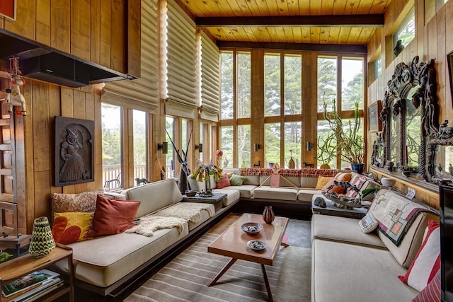 sunroom / solarium with lofted ceiling with beams, plenty of natural light, and wood ceiling