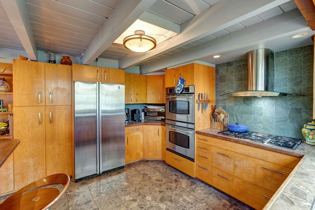 kitchen featuring wall chimney exhaust hood, beam ceiling, tile countertops, backsplash, and appliances with stainless steel finishes