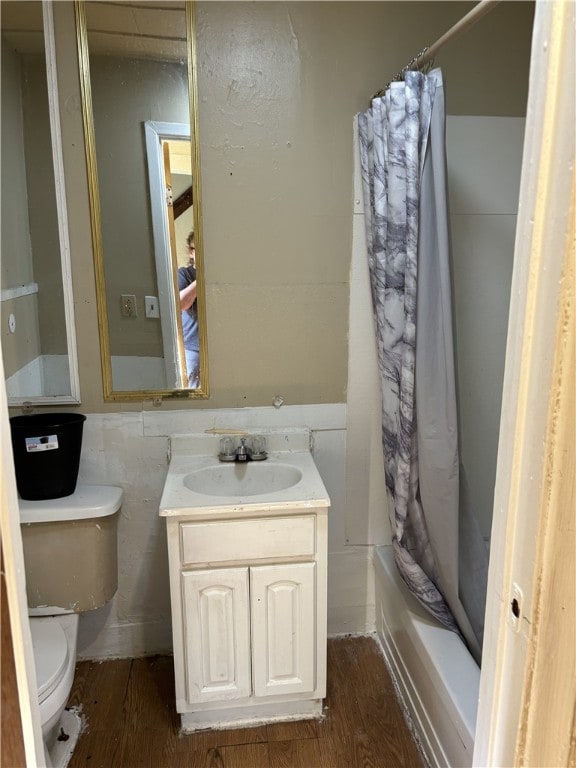 full bathroom with hardwood / wood-style flooring, shower / bath combination with curtain, toilet, and vanity