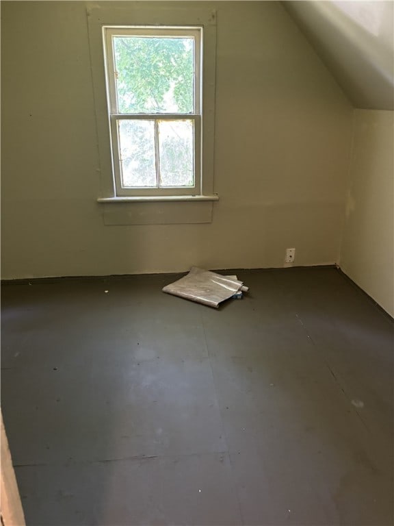 additional living space featuring vaulted ceiling