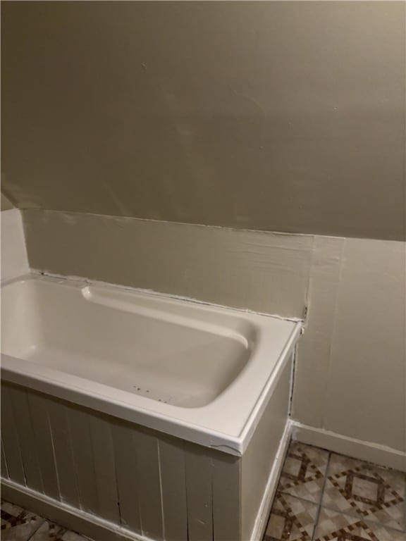 bathroom with tile patterned floors and a bathing tub