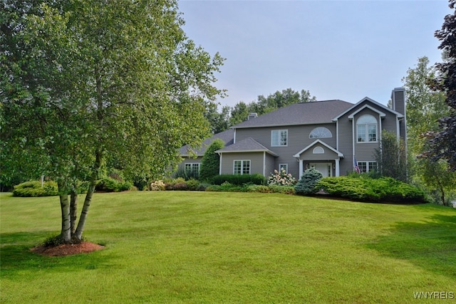 view of front of house featuring a garage and a front yard