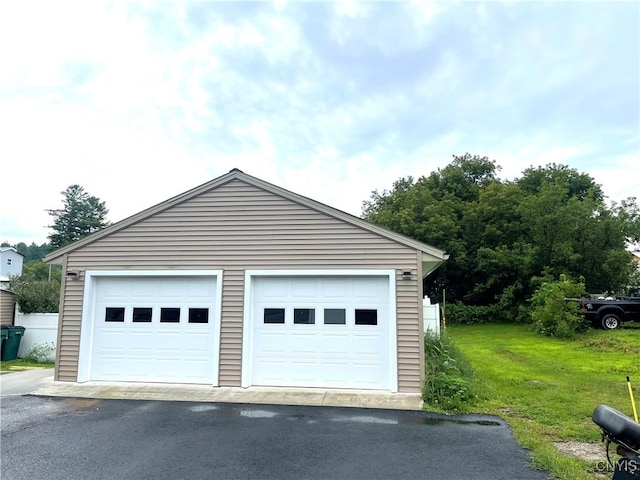 garage featuring a lawn