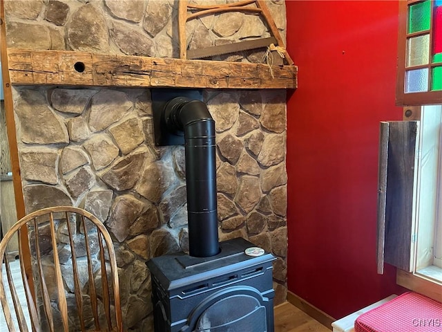 room details featuring a wood stove and baseboards