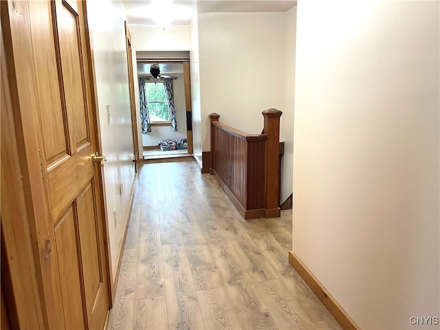 corridor with light hardwood / wood-style floors