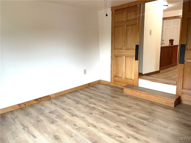 spare room with light hardwood / wood-style flooring