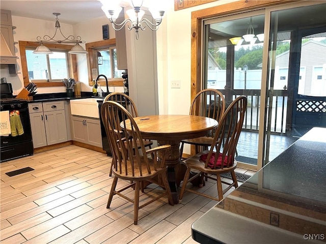 dining room with an inviting chandelier and wood tiled floor