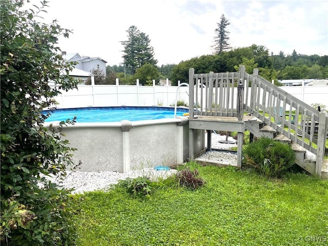 view of pool with a fenced in pool and fence
