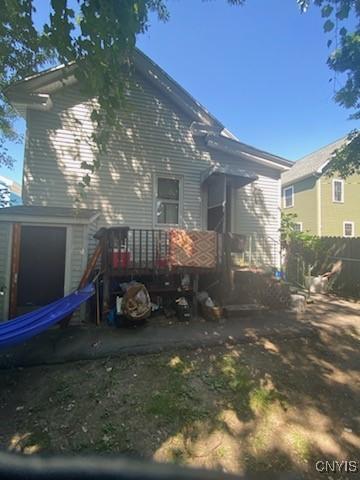 rear view of property with a garage