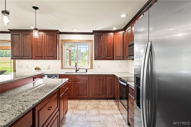 kitchen featuring appliances with stainless steel finishes, a healthy amount of sunlight, sink, and pendant lighting