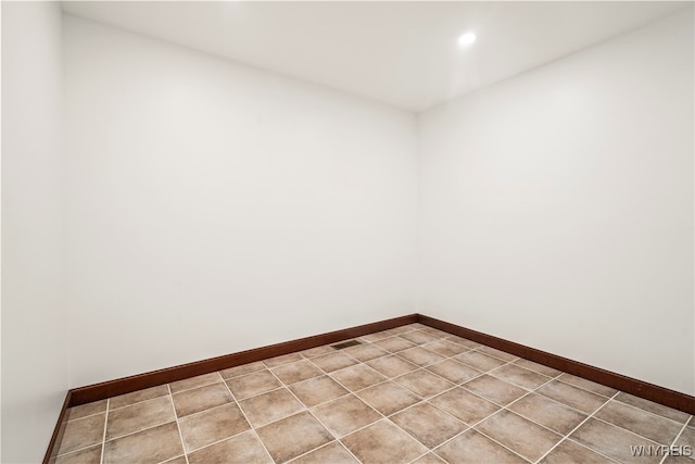 unfurnished room with light tile patterned flooring