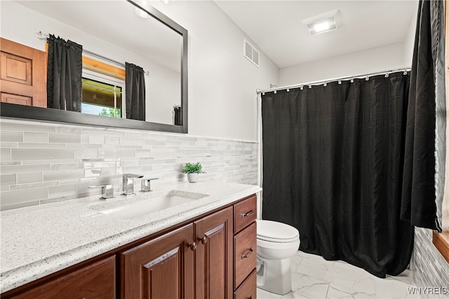 bathroom featuring toilet, decorative backsplash, and vanity